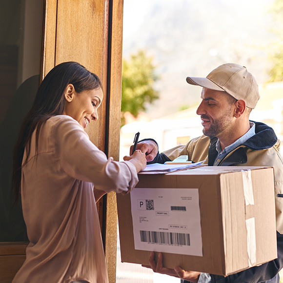 Services_Wholesalers-&-Distributors_580x580 Happy lady signing for package for deliveryman to promote Howard Insurance Brokers - Wholesale and Distribution Insurance