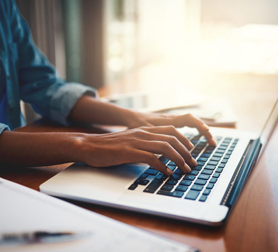 Lady working on computer to promote Howard Insurance Brokers -Contractors Insurance