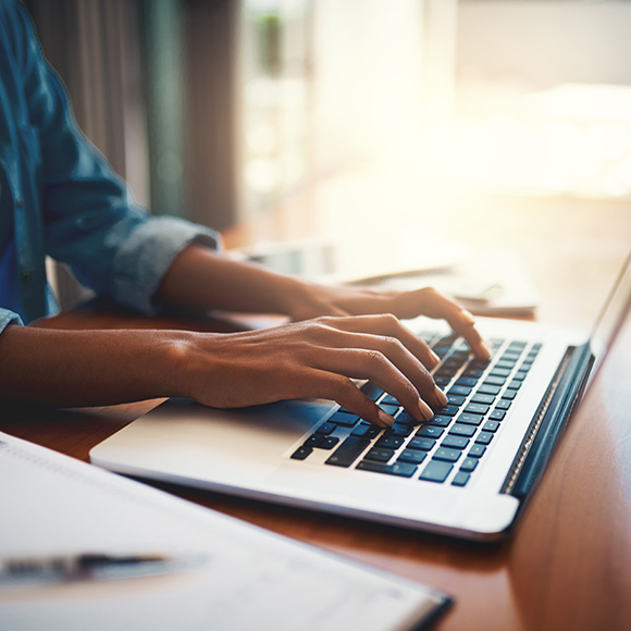 Lady working on computer to promote Howard Insurance Brokers -Contractors Insurance